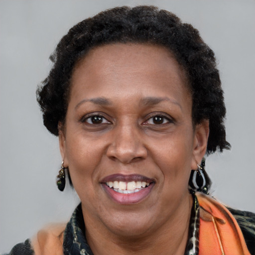 Joyful black adult female with short  brown hair and brown eyes