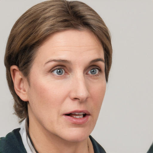 Joyful white adult female with medium  brown hair and grey eyes