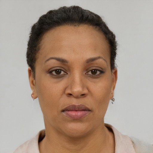 Joyful black adult female with short  brown hair and brown eyes
