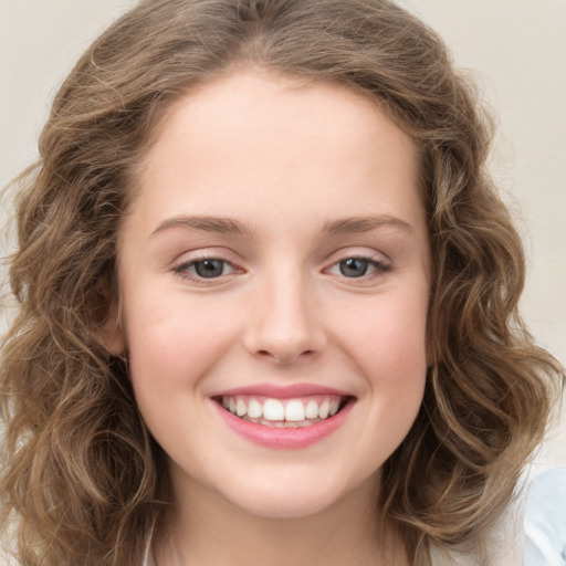 Joyful white young-adult female with long  brown hair and green eyes