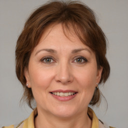 Joyful white adult female with medium  brown hair and brown eyes