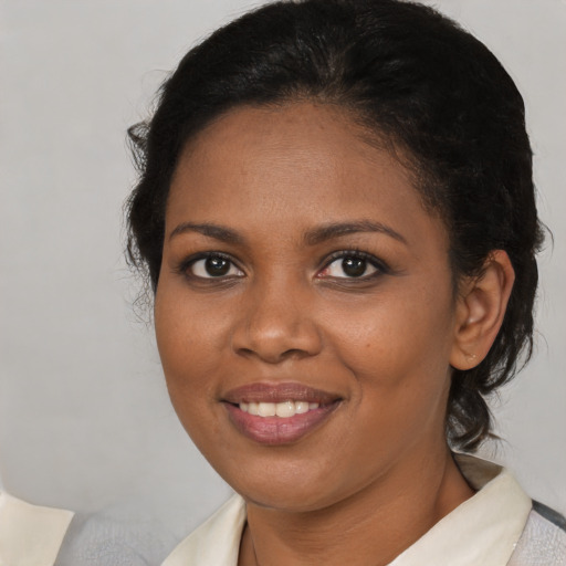 Joyful black young-adult female with medium  brown hair and brown eyes