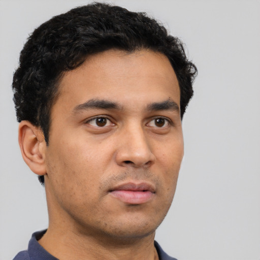 Neutral latino young-adult male with short  brown hair and brown eyes