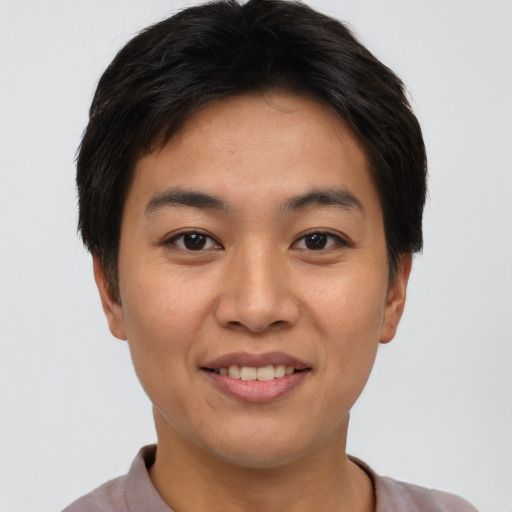 Joyful asian young-adult female with short  brown hair and brown eyes