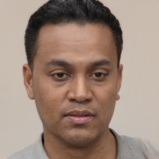 Neutral latino young-adult male with short  black hair and brown eyes