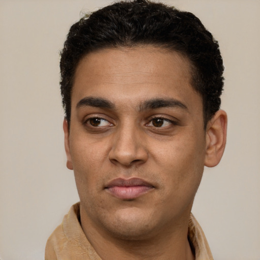 Joyful latino young-adult male with short  brown hair and brown eyes