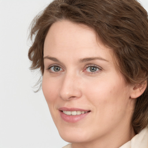 Joyful white young-adult female with medium  brown hair and green eyes