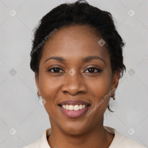 Joyful black young-adult female with short  black hair and brown eyes