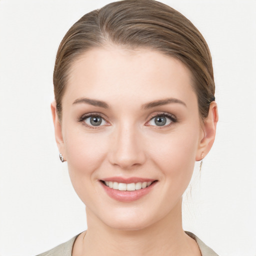 Joyful white young-adult female with medium  brown hair and blue eyes