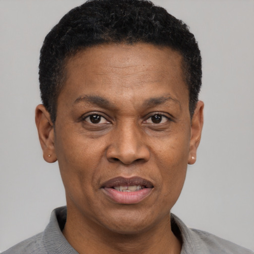 Joyful black adult male with short  brown hair and brown eyes