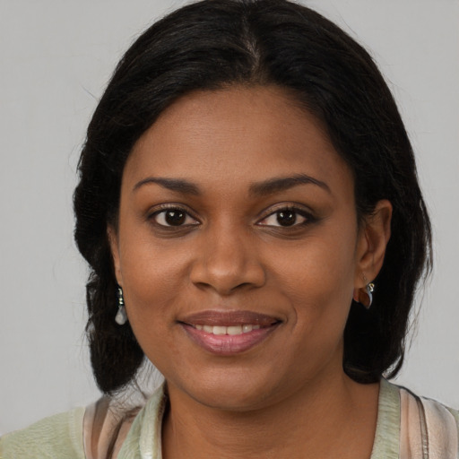 Joyful black young-adult female with medium  brown hair and brown eyes