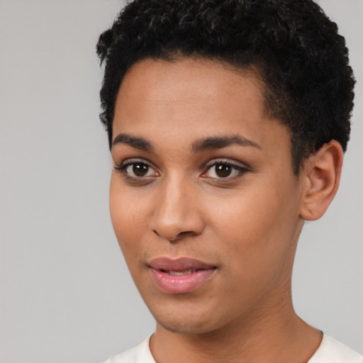Joyful latino young-adult female with short  black hair and brown eyes