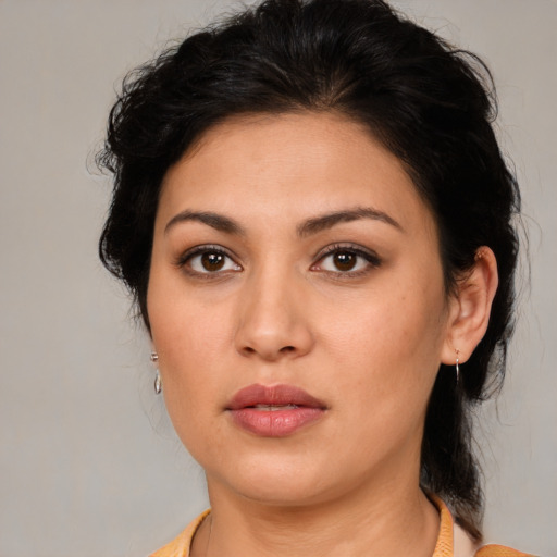 Joyful latino young-adult female with medium  brown hair and brown eyes