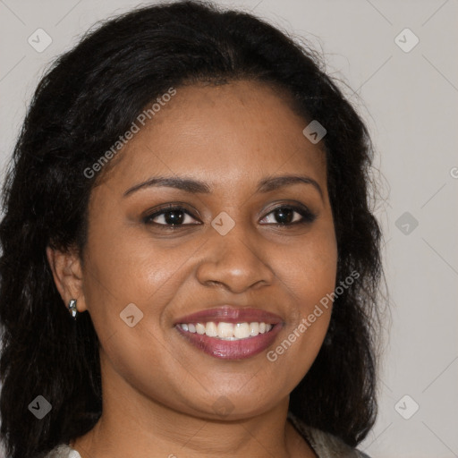 Joyful black young-adult female with long  brown hair and brown eyes