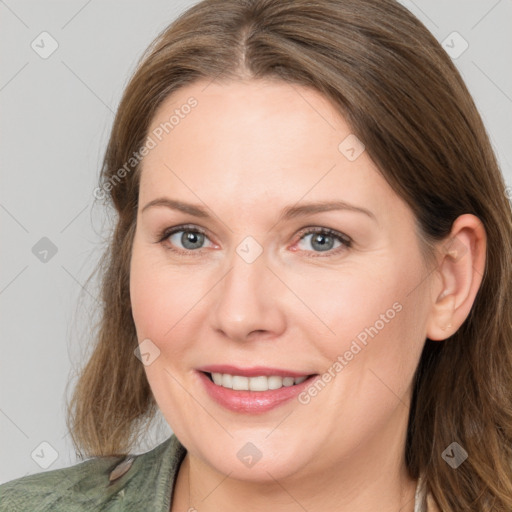 Joyful white adult female with medium  brown hair and grey eyes