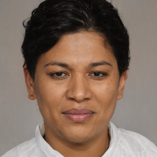 Joyful latino young-adult female with short  brown hair and brown eyes