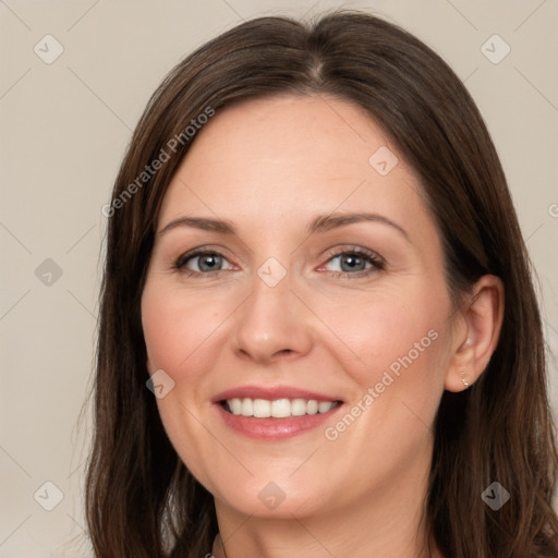 Joyful white adult female with long  brown hair and brown eyes