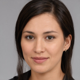 Joyful white young-adult female with medium  brown hair and brown eyes