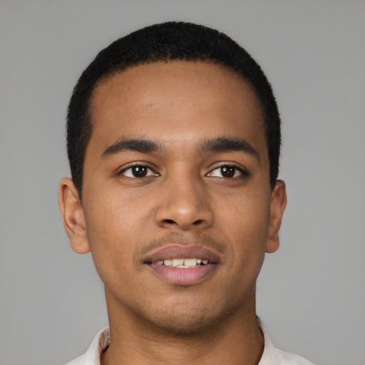 Joyful latino young-adult male with short  brown hair and brown eyes