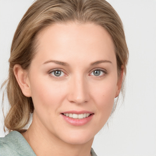 Joyful white young-adult female with medium  brown hair and blue eyes