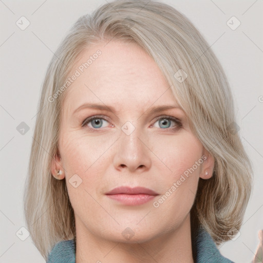 Joyful white adult female with medium  brown hair and blue eyes