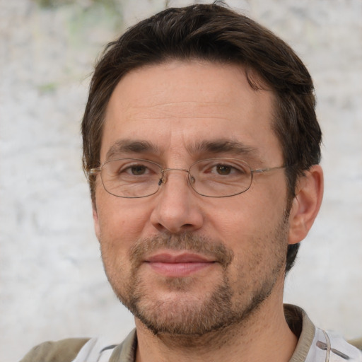 Joyful white adult male with short  brown hair and brown eyes