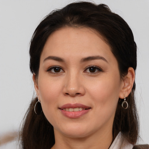 Joyful white young-adult female with long  brown hair and brown eyes