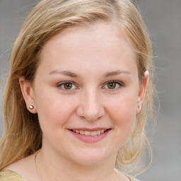 Joyful white young-adult female with medium  brown hair and blue eyes