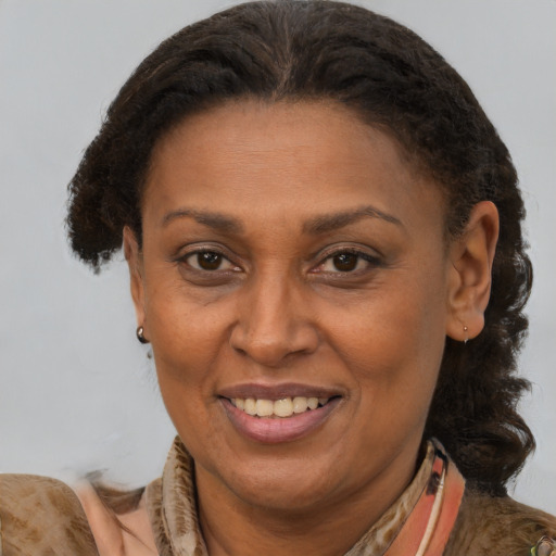 Joyful latino adult female with medium  brown hair and brown eyes