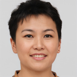 Joyful asian young-adult female with short  brown hair and brown eyes