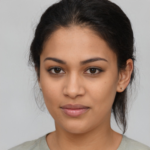Joyful latino young-adult female with medium  brown hair and brown eyes