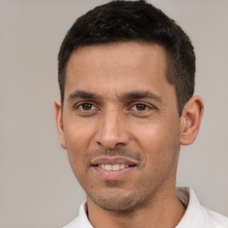 Joyful white young-adult male with short  black hair and brown eyes