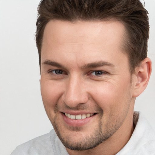 Joyful white adult male with short  brown hair and brown eyes