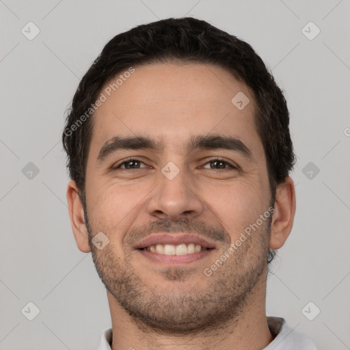 Joyful white young-adult male with short  black hair and brown eyes