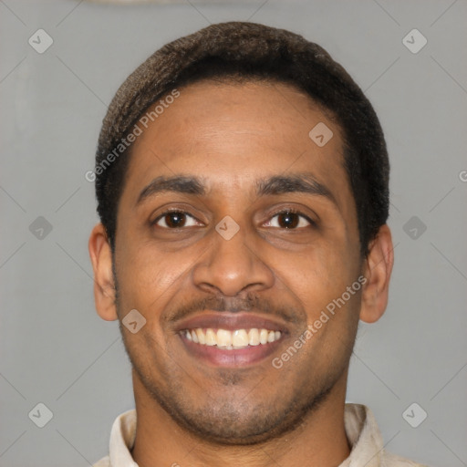 Joyful latino young-adult male with short  brown hair and brown eyes