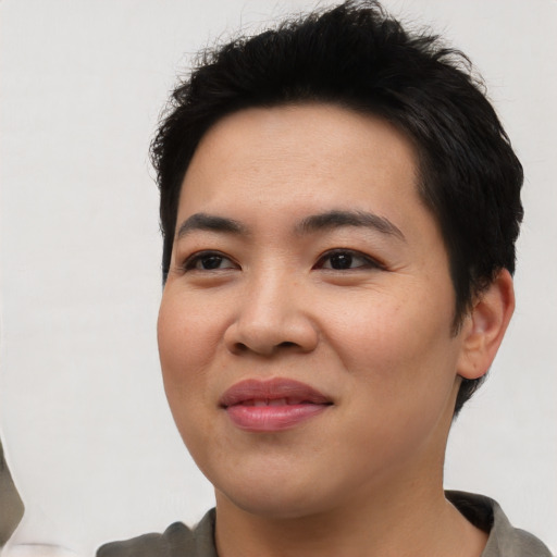 Joyful asian young-adult female with short  black hair and brown eyes