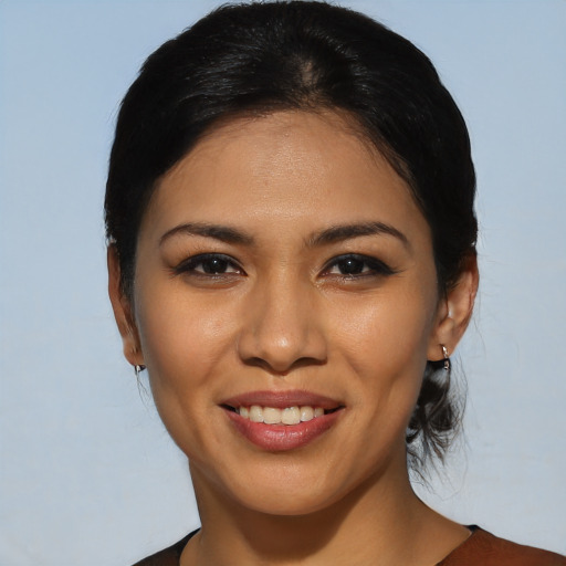 Joyful latino young-adult female with medium  black hair and brown eyes