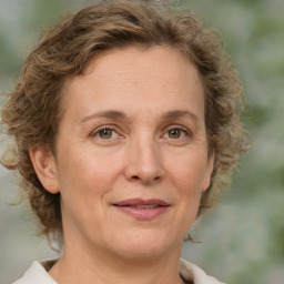 Joyful white adult female with medium  brown hair and green eyes