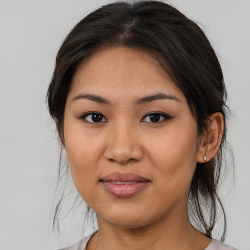 Joyful asian young-adult female with medium  brown hair and brown eyes