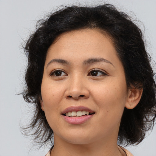 Joyful asian young-adult female with medium  brown hair and brown eyes