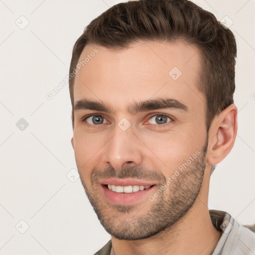 Joyful white young-adult male with short  brown hair and brown eyes