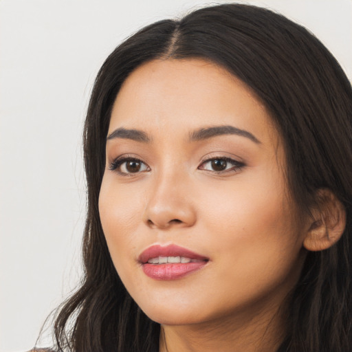 Joyful latino young-adult female with long  black hair and brown eyes