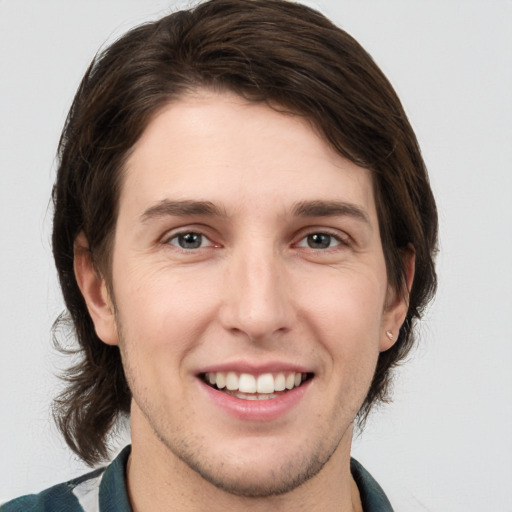 Joyful white young-adult male with medium  brown hair and brown eyes