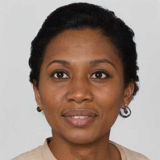 Joyful black young-adult female with short  black hair and brown eyes