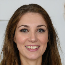 Joyful white young-adult female with long  brown hair and green eyes