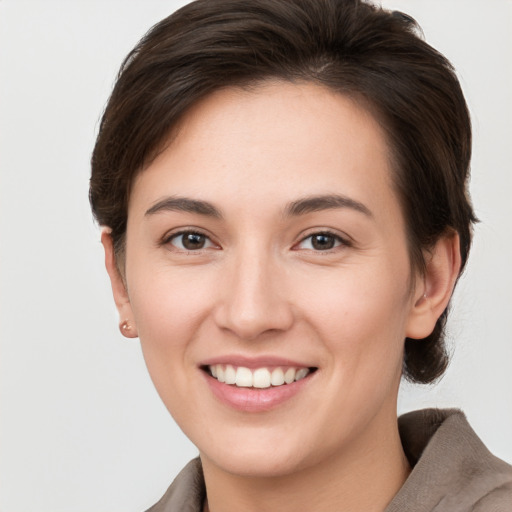 Joyful white young-adult female with short  brown hair and brown eyes