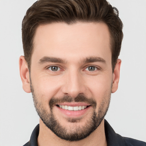 Joyful white young-adult male with short  brown hair and brown eyes