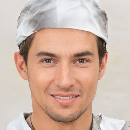 Joyful white young-adult male with short  brown hair and brown eyes