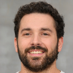 Joyful white adult male with short  brown hair and brown eyes