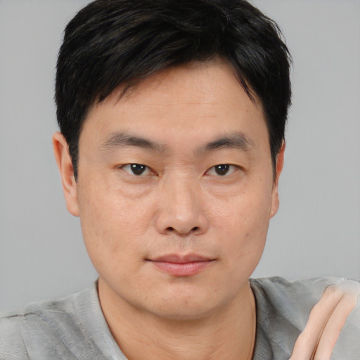 Neutral asian young-adult male with short  black hair and brown eyes